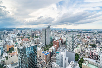 High angle view of modern buildings in city against sky