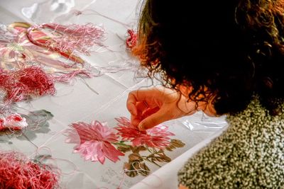 High angle view of woman making design on fabric