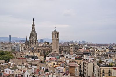 View of buildings in city against sky