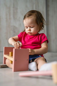 Portrait of cute boy using digital tablet while sitting on table