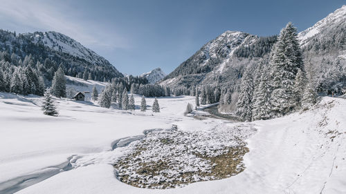 Scenic view of snow covered landscape against sky