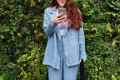 Closeup of hands of beautiful young business woman looking at her smart phone. empty space for text