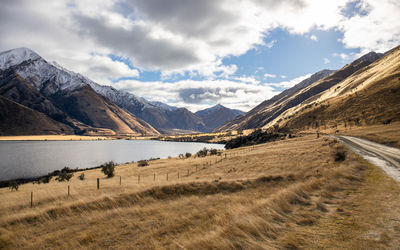 Scenic view of lake and mountains against sky