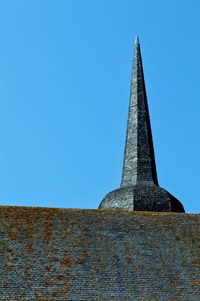 Low angle view of old building against clear blue sky