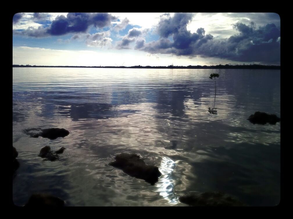 water, sky, transfer print, cloud - sky, tranquil scene, tranquility, scenics, cloudy, auto post production filter, beauty in nature, reflection, cloud, lake, nature, waterfront, sea, idyllic, rippled, rock - object, calm