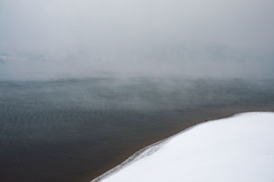 Scenic view of frozen lake against sky during winter