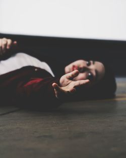 Close-up of woman lying on bed at home