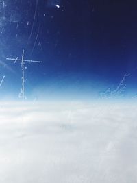 Low angle view of landscape against blue sky