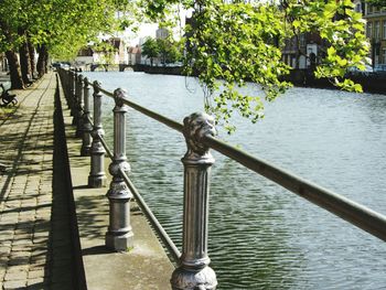 Railing by river in city