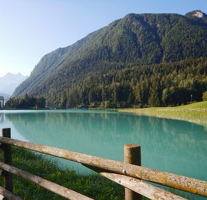 Scenic view of lake and mountains against clear sky