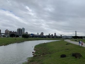 View of city buildings against cloudy sky