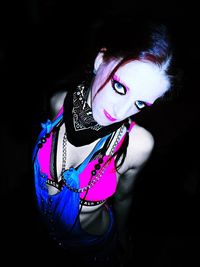 Portrait of woman against black background