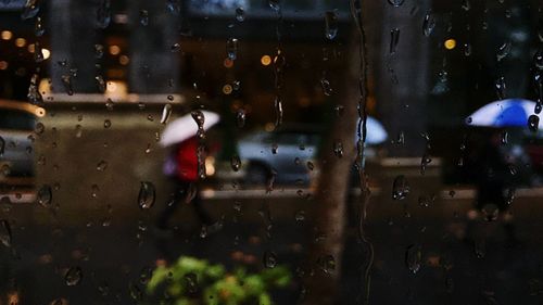 Street seen through wet window during monsoon