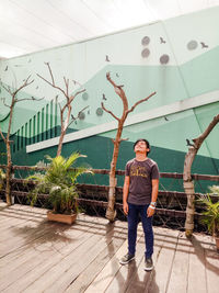 Portrait of man standing against wall