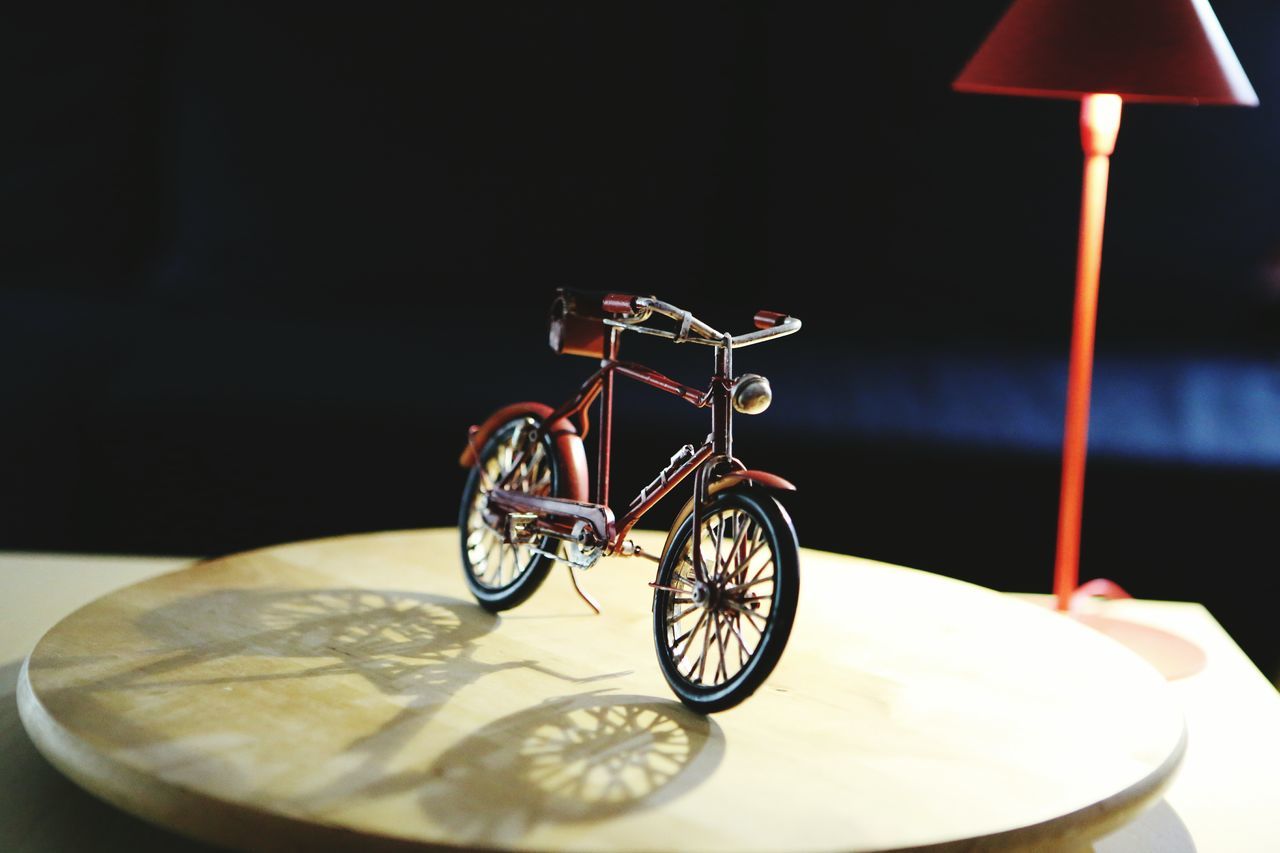 indoors, table, bicycle, still life, bowl, food and drink, no people, plate, transportation, mode of transport, absence, close-up, stationary, land vehicle, spoon, food, circle, reflection, day, high angle view