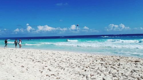 Scenic view of beach against blue sky