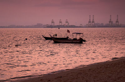 Boat sailing on sea against sky