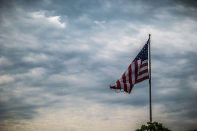 Low angle view of flag against sky during sunset