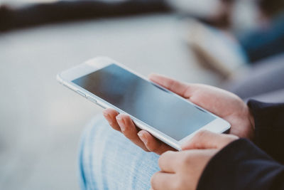 Close-up of hands using mobile phone