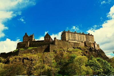 Low angle view of fort against cloudy sky