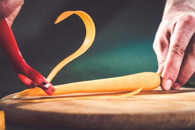 Close-up of man preparing food on cutting board