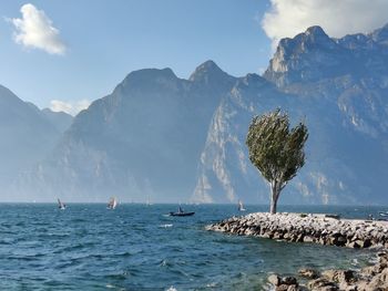 Scenic view of sea and mountains against sky