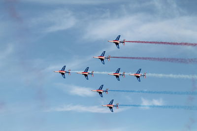 Low angle view of airshow against sky