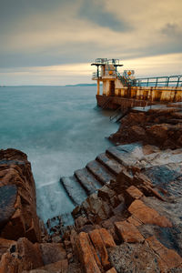 Beautiful seascape sunset scenery of blacrock diving tower on salthill beach in galway city, ireland