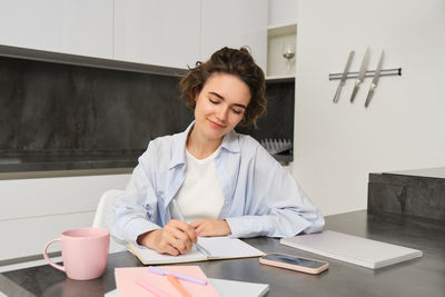 Portrait of young businesswoman working at office