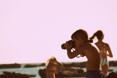 Woman holding camera in sea