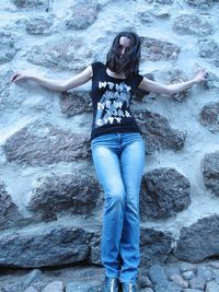 Portrait of young woman on rock