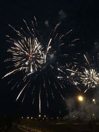 Low angle view of firework display at night