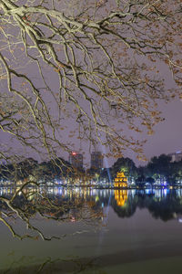 Scenic view of lake against sky at night