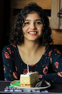 Portrait of smiling young woman cake