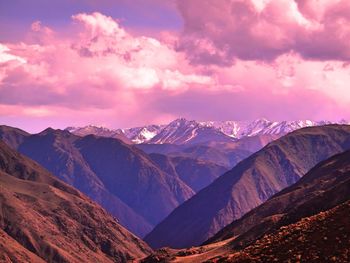 Scenic view of mountains against cloudy sky