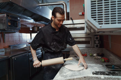 Man kneading dough   sprinkled with flour