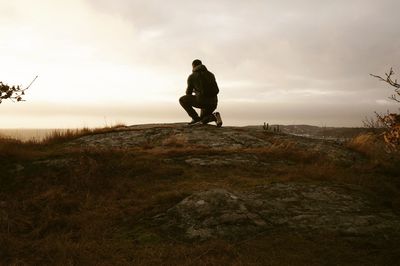 Silhouette man standing on field against sky