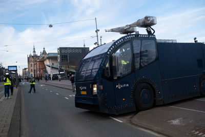 Vehicles on road against buildings in city