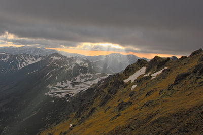 Scenic view of snowcapped mountains against sky during sunset