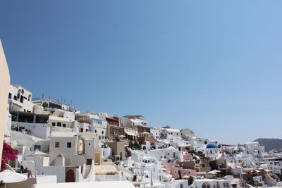 Low angle view of residential buildings against clear blue sky