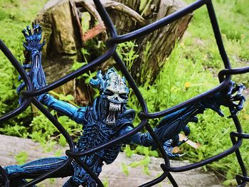 Close-up of bicycle on metal fence