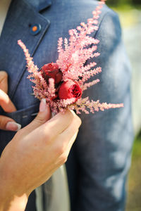 Close-up of hand holding red berries