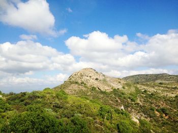 Scenic view of mountains against cloudy sky