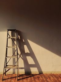 Low angle view of ladder against wall