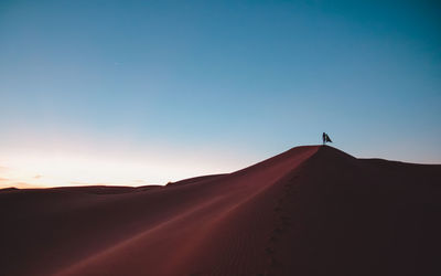 Desert against blue sky during sunset