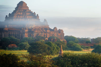 Panoramic view of temple and buildings against sky