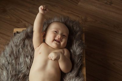 High angle view of baby girl lying on bed at home