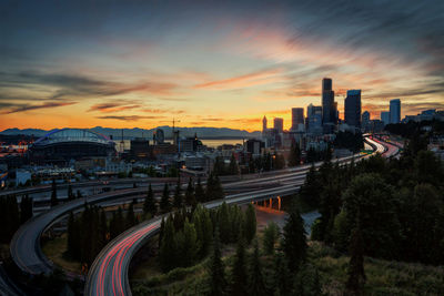 High angle view of bridge and buildings against sky during sunset