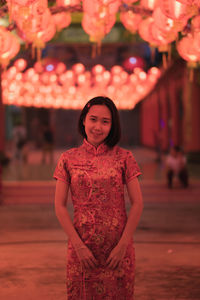 Portrait of young woman standing outdoors
