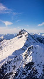 Scenic view of snow covered mountains against sky